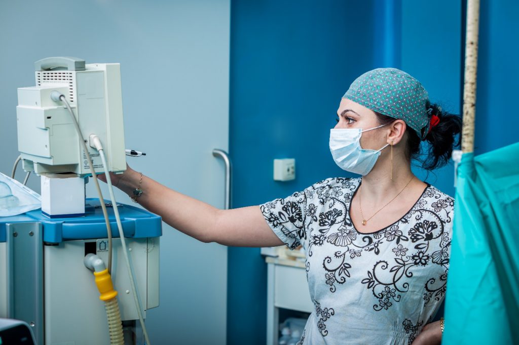 nurse looking at machine