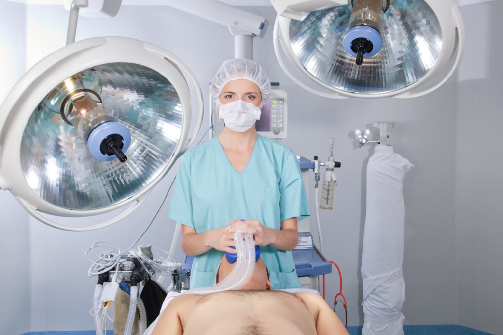 woman giving man anesthesia