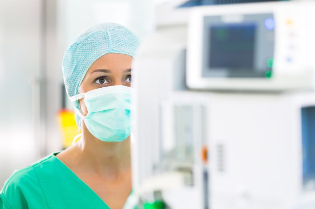 woman looking at anesthesia machine