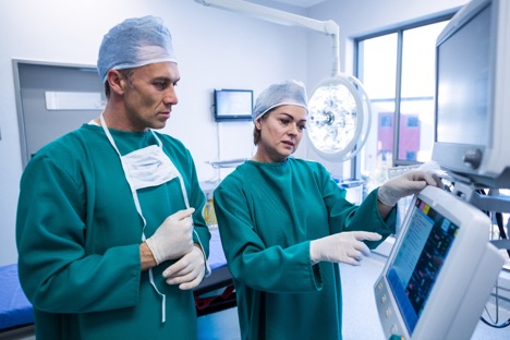 surgical assistants on anesthesia machine screen